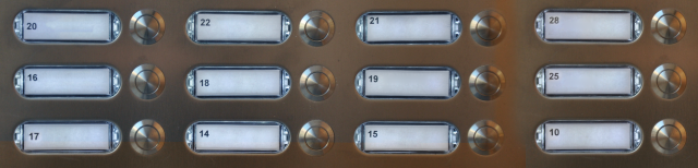 Картина: двенадцать кнопок вызова с реестрами в металлическом каркасе.
